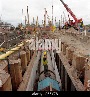 Precast concrete pipes in trench supported by interlocking steel sheet ...