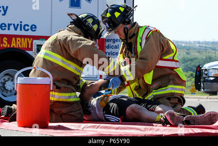 160511-A-MX893-004  Ken Dobberstein (right), a fire fighter on Fort Hood, Texas, stablizes the arm of a simulated crash victim during the annual Fort Protection Exercise at Fort Hood, Texas, May 11. During this exercise more than 400 role players tested the ability of the Force Protection services procedural plan in the event a large scale incident strikes the Fort Hood Community. (U.S. Army photo by Staff Sgt. Gene Arnold, 14th Public Affairs Detachment) (Released) Stock Photo