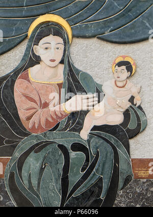 Virgin Mary with baby Jesus, house facade in Lucca, Tuscany, Italy Stock Photo