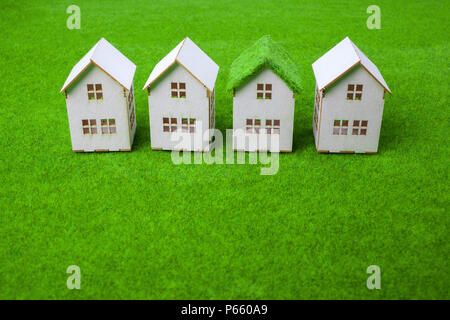 White Houses Arranged In Row On Grassy Field Stock Photo