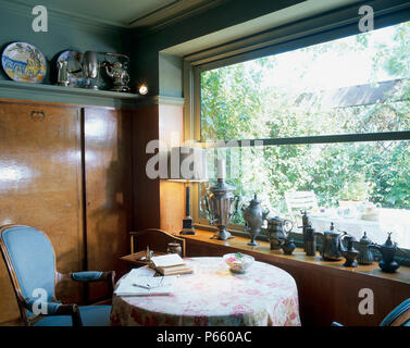 View of table and chairs placed near a window Stock Photo