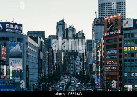 Japanese buildings and traffic in Shinjuku with Park Hyatt Tokyo hotel building in the center. Tokyo, Japan. Stock Photo