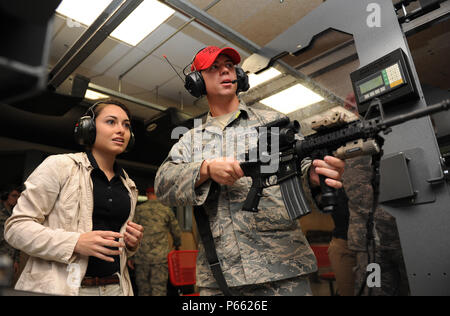 Gabriela Valle-Ramos, University of Alabama Air Force ROTC Cadet, receives M-4 weapon operating instructions from Senior Airman Caleb Gilliard, 81st Security Forces Squadron combat arms instructor, at the 81st SFS CATM range during Pathways to Blue April 15, 2016, Keesler Air Force Base, Miss. Pathways to Blue, a diversity outreach event hosted by 2nd Air Force, the 81st Training Wing and the 403rd Wing, included more than 180 cadets from Air Force ROTC detachments from various colleges and universities. Cadets received hands-on briefings on technical and flying operations and an orientation f Stock Photo