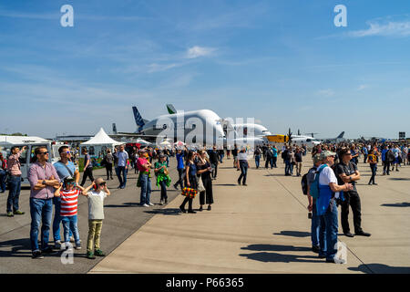 Visitors to the exhibition on the airfield. In the background, outsize cargo freight aircraft Airbus A300-600ST (Super Transporter) or Beluga. Stock Photo