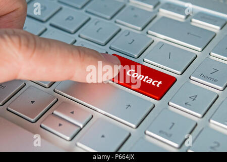 Big red contact us keyboard button. contact inscriptions on the keyboard button, Red button. Stock Photo