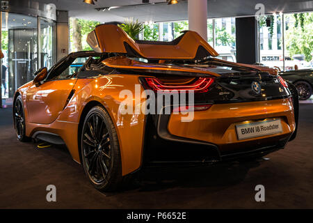 BERLIN - JUNE 09, 2018: Showroom. A plug-in hybrid sports car BMW i8 Roadster. Rear view. Stock Photo