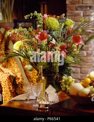 Still-Life of orange llies and lime green chrysanthemums in informal summer floral arrangement Stock Photo