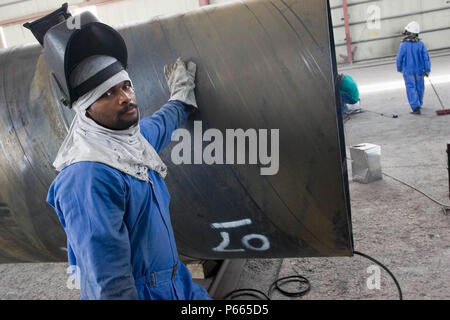Workers at Hyojong Pipe factory, Doha. Stock Photo