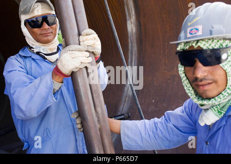Workers at Hyojong Pipe factory, Doha. Stock Photo