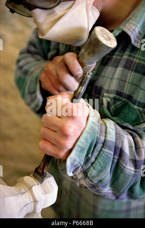 Stonemason using mallet and chisel. Stock Photo