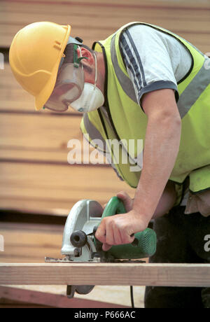 Carpentry and Joinery. Operating a circular portable saw. Stock Photo
