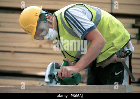 Carpentry and Joinery. Operating a circular portable saw. Stock Photo
