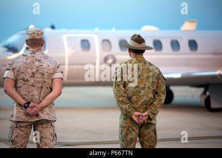 Lt. Col. Scott W. Zimmerman, Forward Coordination Element Officer in Charge, and Col. Brian J. Bailey, Deputy Commander of Northern Command, await the III Marine Expeditionary Force Commanding General Lt. Gen. Lawrence D. Nicholson’s arrival on Royal Australian Air Force Base Darwin, Northern Territory, Australia, May 9, 2016. Nicholson will visit Marines with Marine Rotational Force – Darwin and meet with Australian Defence Force leaders to further strengthen the ADF and U.S. force’s partnership. MRF-D is six-month deployment of Marines to Darwin where they will engage in multiple training ex Stock Photo