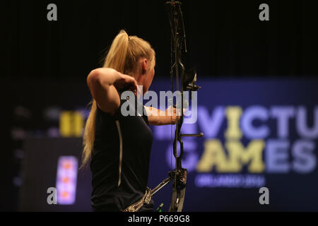 U. S. Army Spec. Chasity Kuczer, surveys her shot during the Open Compound Gold Medal match of the archery competition, winning a silver medal for the United States team at the 2016 Invictus Games.  Kuczer, a locomotive mechanic, is an Army athlete from Pulaski, WI, currently stationed at the Warrior Transition Unit, Fort Knox, KY.  She is one of 35 Soldier and Veteran Army athletes representing the US team during the Invictus Games in Orlando, FL, May 8-12.  Invictus Games, an international adaptive sports tournament for wounded, ill and injured service members and Veterans, features about 50 Stock Photo