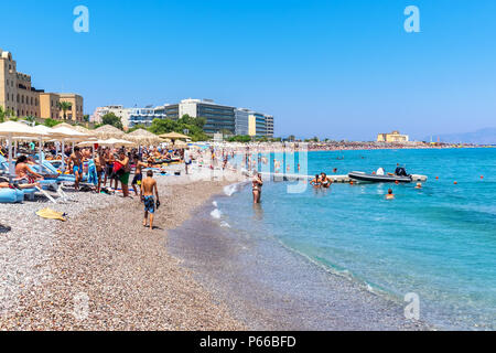 People relaxing and sunbathing at Elli Beach, the main beach of Rhodes Town. Greece Stock Photo