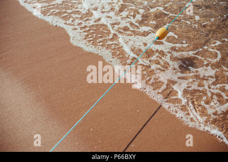 Soft wave of blue ocean on sandy beach. Background. Stock Photo