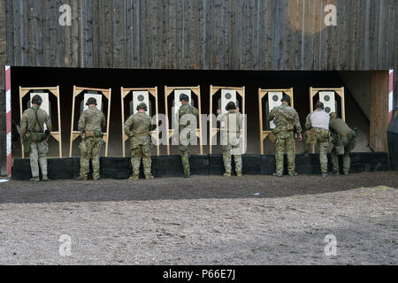 A U.S. Soldiers assigned to 1st Battalion, 10th Special Forces Group (Airborne) check their targets during a M9 pistol range on Panzer Kaserne in Boeblingen, Germany, May 4, 2016. (U.S. Army photo by Visual Information Specialist Adam Sanders/RELEASED) Stock Photo