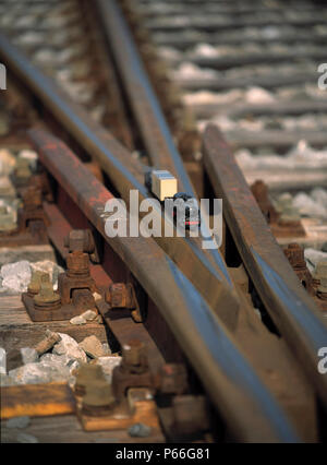 Scale Model of Freight Train crossing Railroad Track Stock Photo