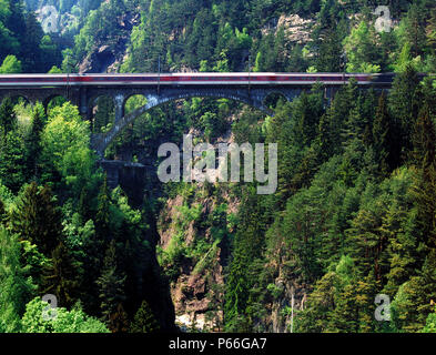 Intercity train on Saint Gotthard railway track - bridge (near the village of Wassen) - Swiss Alps - canton of Uri - Switzerland Stock Photo