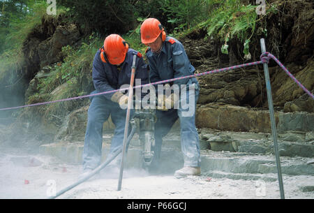 Construction Workers using a Jackhammer Stock Photo