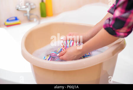 Women separate cloth from basket into the basin , hand wash Stock Photo by  ©dream5_5_5@hotmail.com 317932068