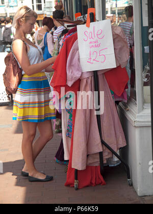 Clothes shopping from a stall in the North Laine area of Brighton Stock Photo