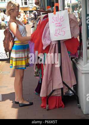 Clothes shopping from a stall in the North Laine area of Brighton Stock Photo