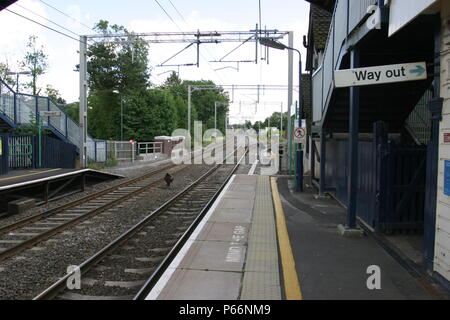 General platform view of Berkswell station, Warwickshire showing pedestrian exit and overhead electric catenary. 2007 Stock Photo