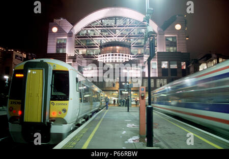 Night at Charing Cross Station, London and a South Eastern Trains Class 375 Electrostar awaits to depart whilst a Class 466 speeds away Stock Photo