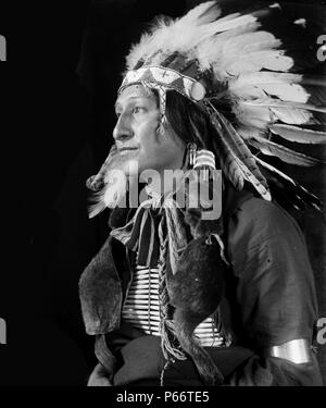 Joe Black Fox by Photographer Gertrude Käsebier, 1852-1934. Sioux Indian from Buffalo Bill's Wild West Show. Joe Black Fox, half-length portrait, seated, facing left. Dated ca. 1900 Stock Photo