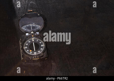 old compass on a wooden brown background with space for text Stock Photo