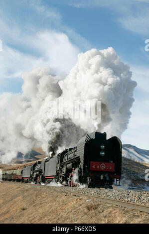 Double headed QJ 2-10-2 steam locomotives hauling a heavy freight train ...