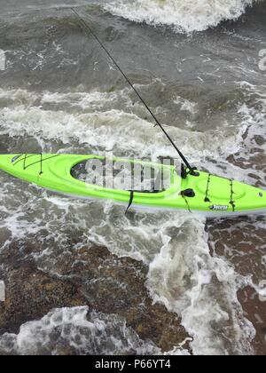 NEW YORK – Crews from the Coast Guard and local agencies are searching for a possible missing person after an unmanned kayak was located near the rocks at Lighthouse Point in New Haven, Connecticut, May 15, 2015. At approximately 12:30 p.m. May 15, watchstanders at Coast Guard Sector Long Island Sound received a call from a good Samaritan reporting an unmanned bright green, one-person kayak drifting onto the rocks at Lighthouse Point. (U.S. Coast Guard Photo) Stock Photo