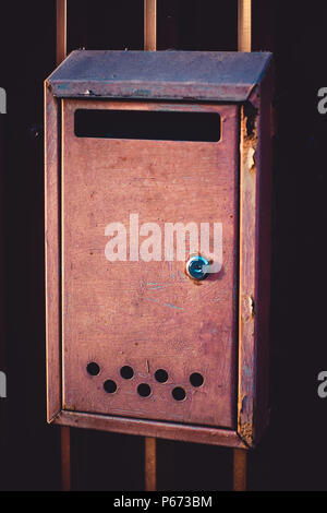 letterbox of a plum color on a fence close-up Stock Photo