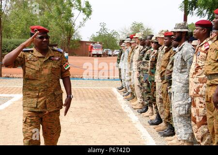 General Pingrenoma Zagre, Chief of Defense Staff for Burkina Faso Armed Forces, salutes multinational Western Accord 2016 participants during the exercise’s Closing Day Ceremony May 13, 2016 at Camp Zagre, Ouagadougou, Burkina Faso. The two-week command post exercise, which began May 2, brought together 15 West African Nations, 7 NATO European countries and the U.S. to work as a multinational headquarters to build interoperability and shared understanding. (U.S. Army photo by Staff Sgt. Candace Mundt/Released) Stock Photo
