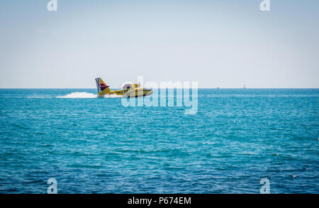 Firefighting aircraft in an emergency situation, water intake. Stock Photo