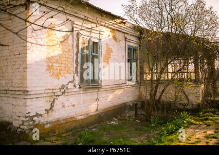 old abandoned house with cracks in summer Stock Photo