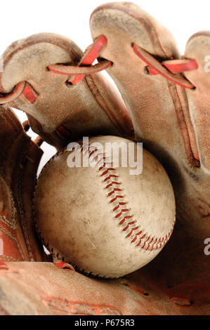 old vintage baseball glove with the baseball held in the palm isolated over white background Stock Photo