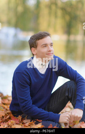Teenage boy outdoors in a pullover sweater Stock Photo