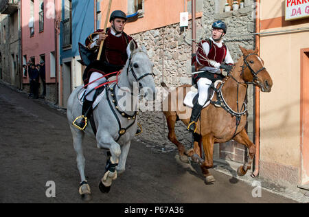 Couple ride reckless horserace 'Sa Carrela e Nanti', during the carnival at Santu Lussurgiu, Oristano, Sardinia, Italy, Europe Stock Photo