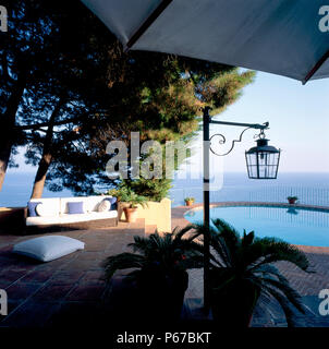 View of a seating arrangement beside a swimming pool Stock Photo