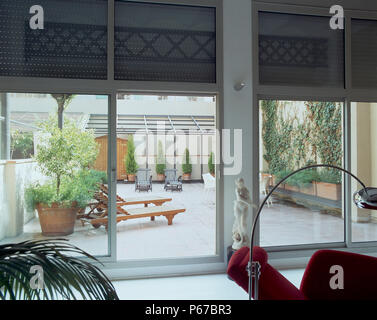 View of a spacious patio through glass doors Stock Photo