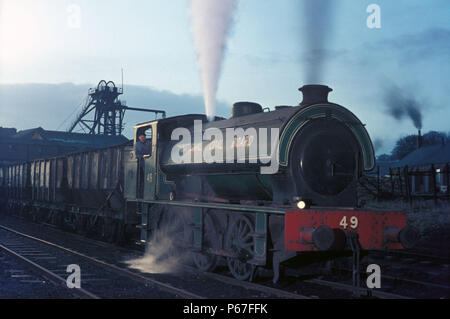 Dawn at Backworth. The classic shape of Hunslet's 0-6-0 Austerity Saddle Tank is evidenced by Backworth No.49 caught in Eccles colliery yard at dawn o Stock Photo