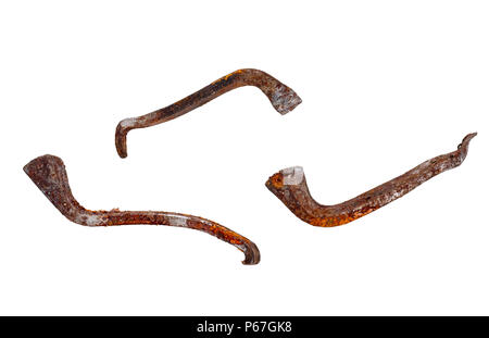 Very old nails, twisted and rusty. From old horse shoe. Isolated on white. Stock Photo