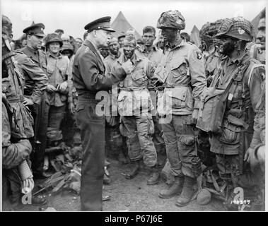 General Dwight D. Eisenhower gives the order of the day;   'Full victory--nothing else' to paratroopers somewhere in England;   just before they board their airplanes to participate in the first assault in the invasion of the continent of Europe; World War Two 1944 Stock Photo