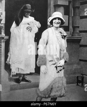 The Duchess of York (later Queen Elizabeth) walks alongside a Nurse, whom is carrying the young Princess Elizabeth (later Queen Elizabeth II), attend the christening of the newborn Princess. Stock Photo