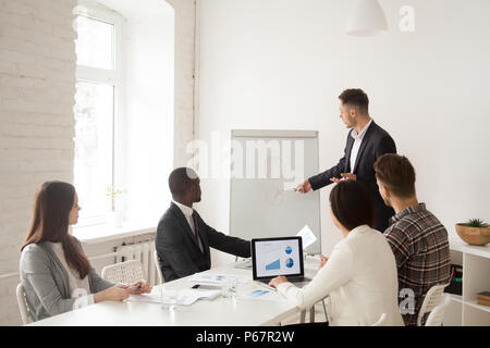 Confident speaker making presentation on flipchart for business  Stock Photo
