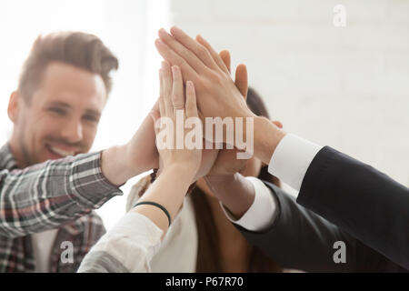Close up of colleagues giving high five celebrating successful s Stock Photo