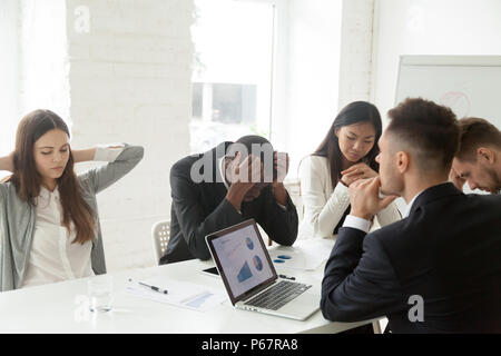 Upset colleagues feeling down because of company bankruptcy news Stock Photo