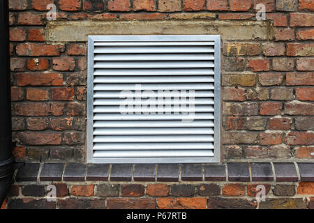 House ventilation grill on brick wall facade Stock Photo